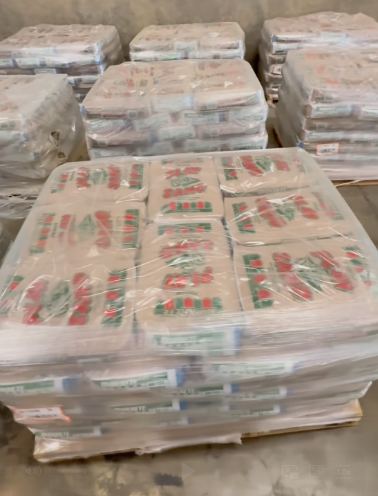 Pallets of heavy, shrink-wrapped bagged product handled by the Honeybee team
