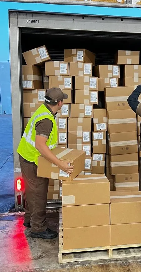 Carrier loading packed Honeybee orders onto a truck for final delivery